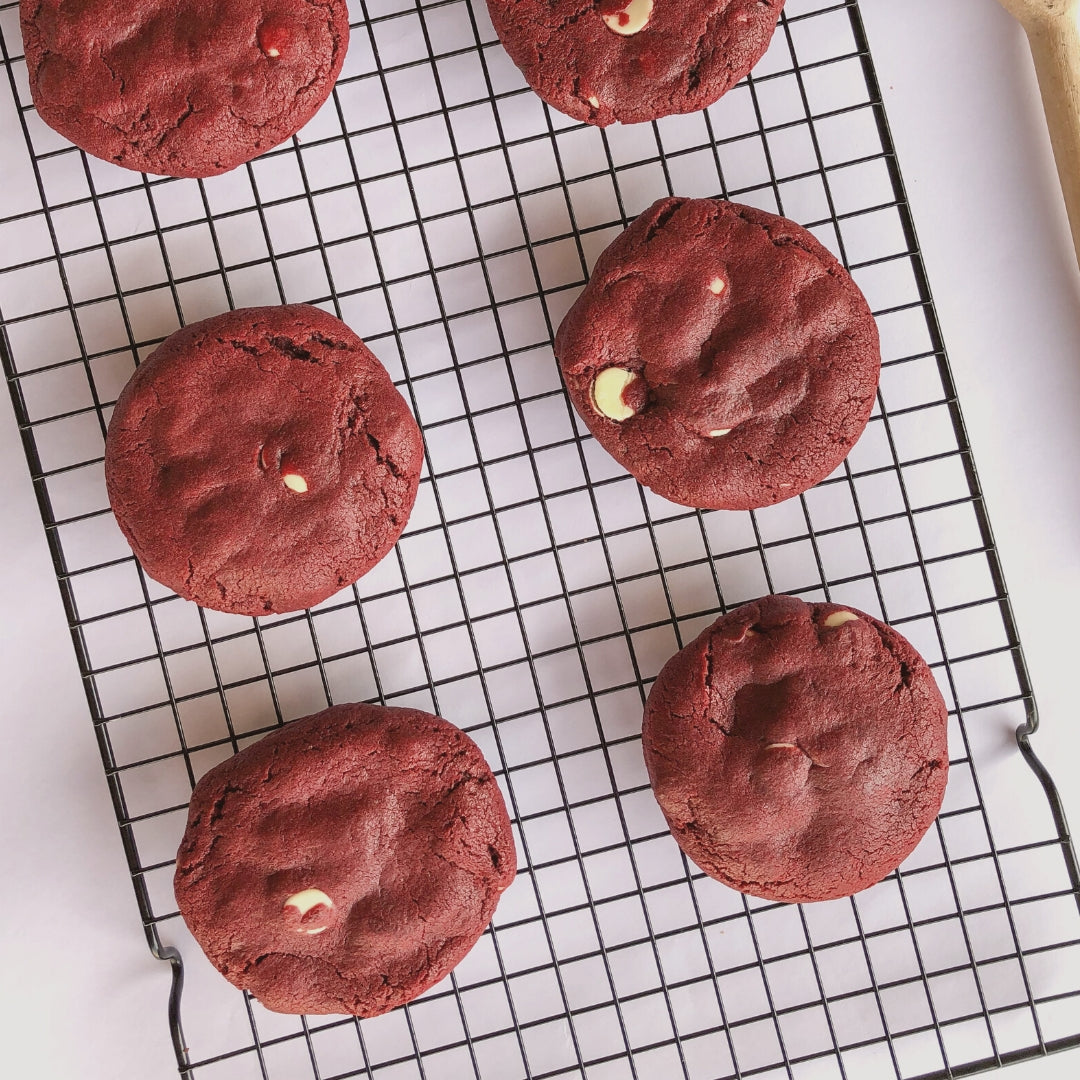 red velvet chocolate chip cookies on rack