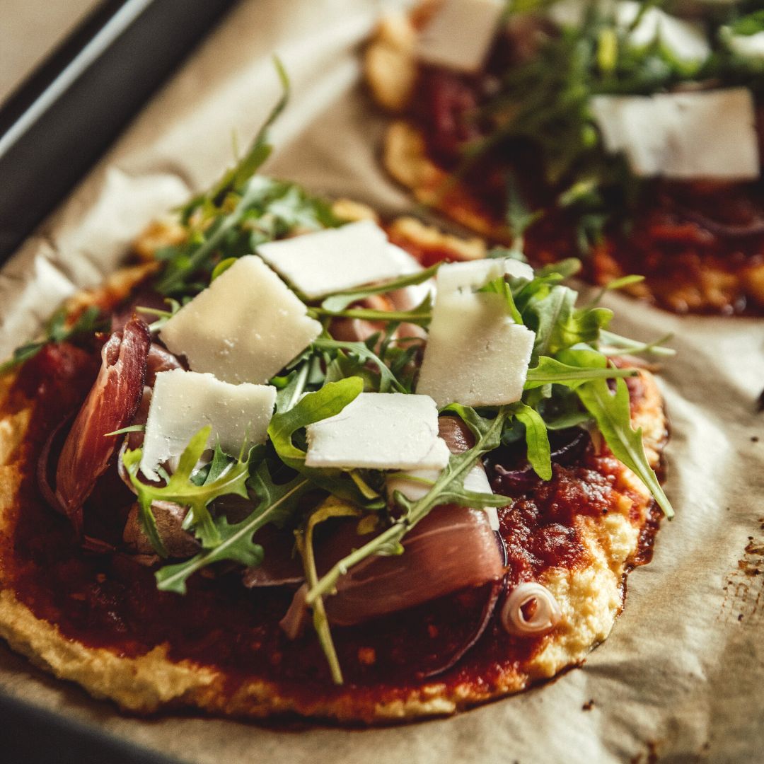 home made pizza with pancetta, arugula, mozzarella cheese