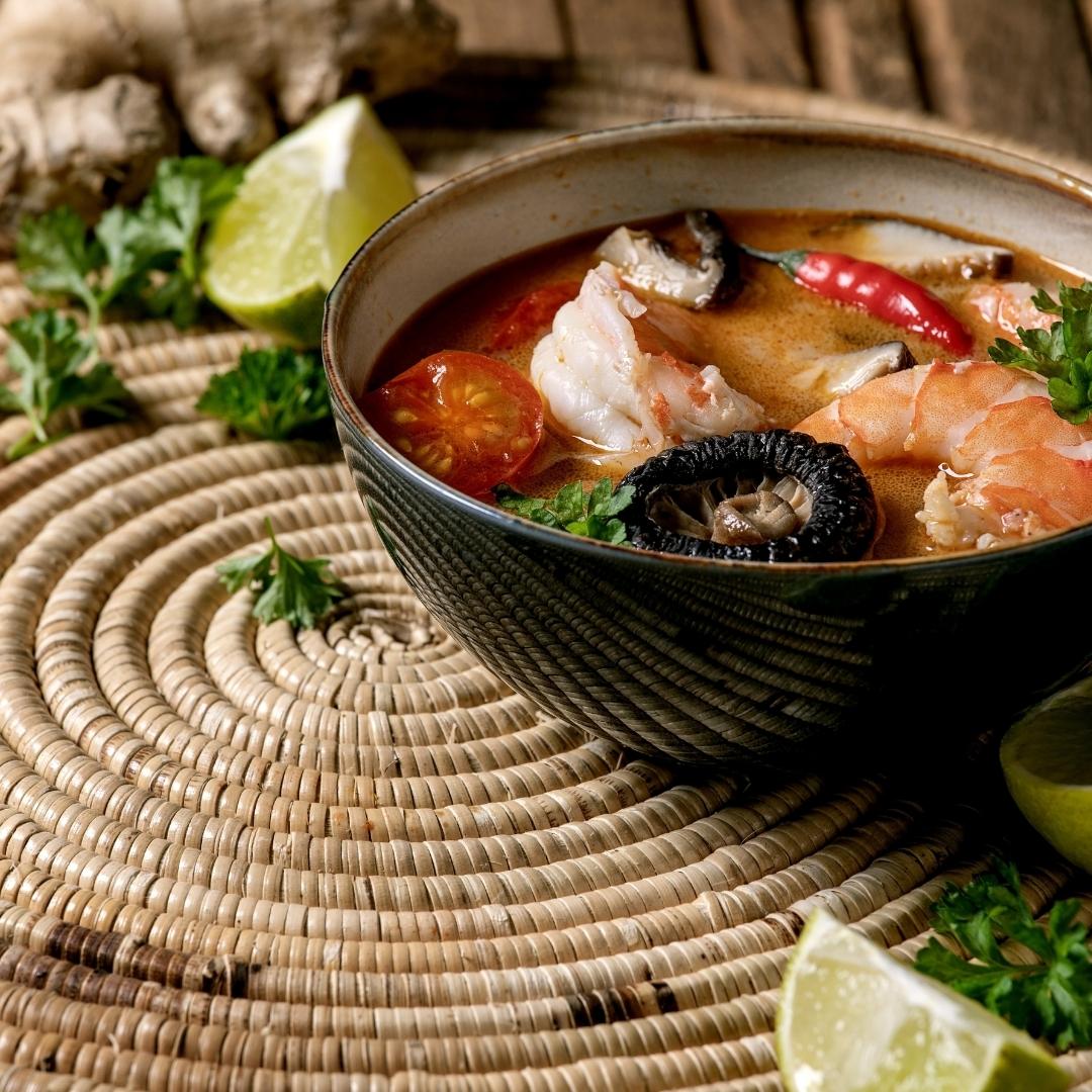 Thai soup with shrimp in bowl, ginger, lime, 